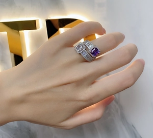 Close-up of stacked 925 silver rings featuring square white and purple gemstones
