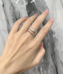 Detailed view of layered sterling silver rings with micro-set rectangular zircons