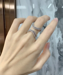 Close-up of a silver double-layer wave ring with micro-pave cubic zirconia on hand