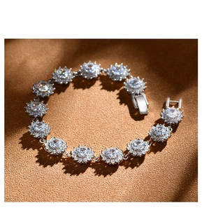 Macro shot of silver sunflower links with sparkling round diamonds and secure clasp