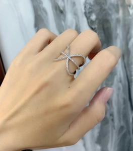 Macro shot of 925 sterling silver criss-cross ring with white pavé cubic zirconia