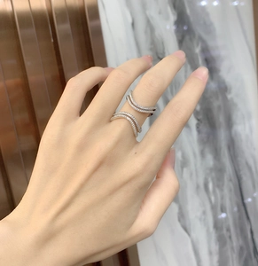 Close-up of double-layered wave ring with micro-paved white zircons on silver finish