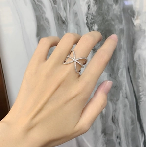 Detail of 925 silver X-shaped ring featuring pave-set sparkling cubic zirconia