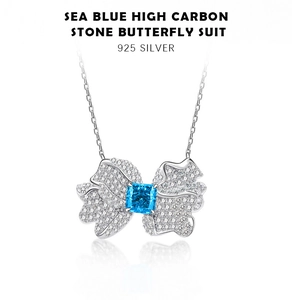 Macro detail of 925 sterling silver butterfly pendant with sea blue square-cut stone