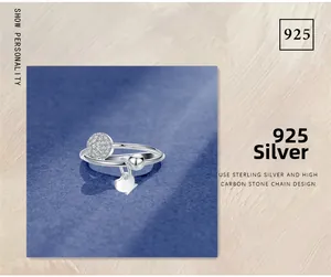 Macro detail of 925 sterling silver ring with pavé diamond disk and cat charm