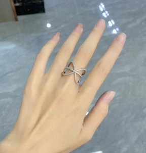 Macro shot of 925 silver crisscross ring featuring a full pavé setting of sparkling stones