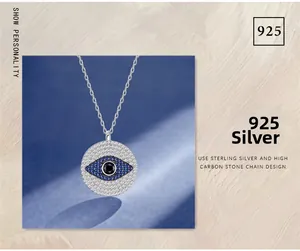 Macro detail of S925 sterling silver evil eye pendant with blue and white stones