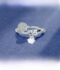 Macro view of 925 sterling silver ring with micro-set stones and fish charm detail