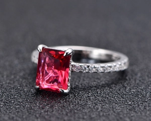 Macro side view of 925 silver ring featuring a large rectangular red emerald-cut gemstone