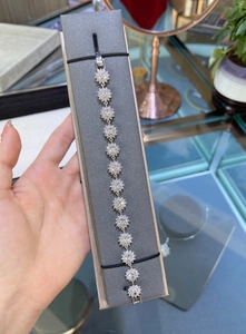 Detail of S925 sterling silver sunflower bracelet with sparkling zirconia clusters