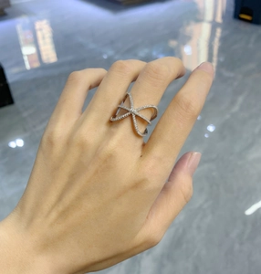 Detailed view of sterling silver criss-cross X ring with pave set sparkling cubic zirconia
