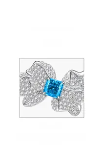 Macro detail of butterfly ring with square blue gem and microscope micro-setting process