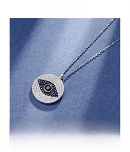 Macro detail of S925 sterling silver evil eye pendant with micro-set white cubic zirconia
