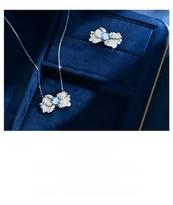 Detail view of 925 silver butterfly necklace and ring set with ice blue gemstone