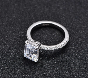 Close-up of 925 sterling silver stamp and emerald-cut stone with four-prong setting