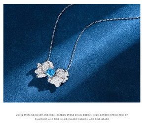 Macro shot of 925 silver butterfly necklace with pave carbon diamonds and square blue gemstone