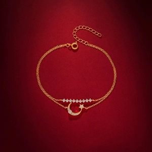 Detail of gold-plated S925 silver double-layered bracelet with star and moon charms