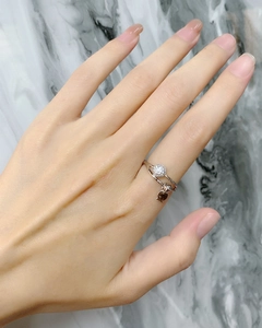 Detail of 925 sterling silver ring with pavé round stone and dangling fish charm