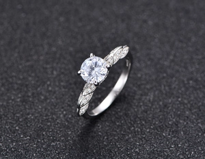 Macro detail of 925 silver ring featuring four-prong solitaire setting and braided band design