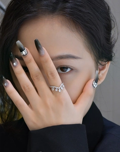 Close-up of S925 silver V-shaped crown ring with drop-shaped zircons on finger