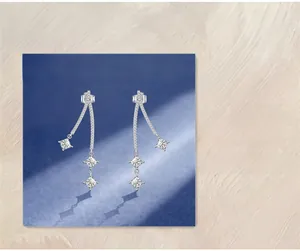 Macro detail of S925 sterling silver long drop earrings with square cut high carbon stones