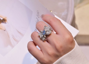 Detailed view of S925 sterling silver butterfly ring with blue gemstone on model's hand