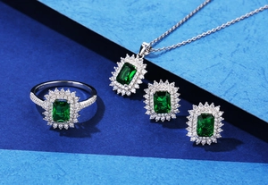 Detail of S925 silver jewelry set with emerald-cut stones and halo diamond setting