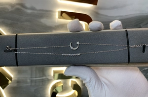 Detail of S925 sterling silver star and moon double-layer bracelet with sparkling zircons