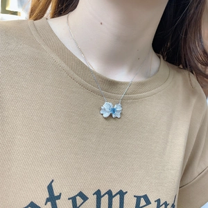 925 silver necklace with blue gemstone butterfly pendant on model neckline
