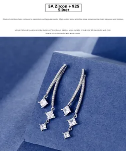 Close-up of 925 sterling silver drop earrings with triple square-cut cubic zirconia stones