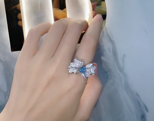 Close-up of a 925 silver butterfly wing ring with a heart-shaped blue carbon diamond stone