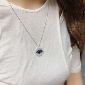 S925 sterling silver evil eye necklace with blue and white zircon pavé worn on model