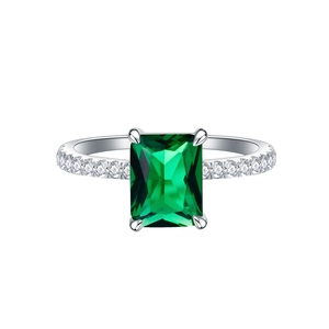 925 silver ring featuring emerald cut green stone and pave diamonds on white background