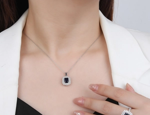 Detail view of S925 silver necklace featuring a sunflower-set rectangle blue gemstone