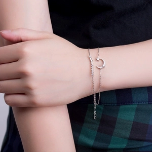 Double-layered S925 sterling silver star and crescent moon bracelet with zircons on a model