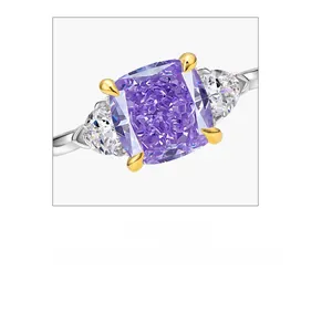 Macro view of cushion cut purple gem ring with pear-shaped side stones on silver band