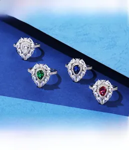 Detailed view of pear-cut emerald and sapphire rings with double-layer micro-pave diamonds