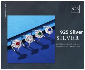 Macro shot of 925 sterling silver rings with pear-shaped emerald and colorful gemstones