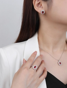 Detailed view of S925 silver jewelry set with red emerald-cut gems on model