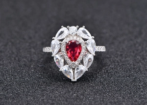 Macro view of water drop red gemstone ring with S925 silver and pave diamonds