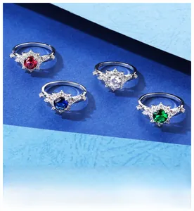 Macro detail of S925 silver rings with red, white, blue and green gems in snowflake setting