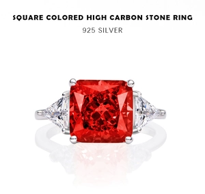 Macro detail of 925 silver ring featuring square red carbon diamond with side stones