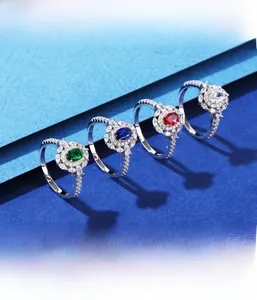 Macro view of four 925 silver halo rings showing micro-pave setting with colorful stones