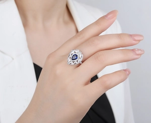 Luxurious S925 silver ring with water drop blue gemstone on a model in white suit