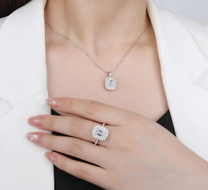 Close-up of S925 sterling silver jewelry set with emerald cut stones on a model