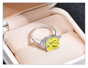 Macro shot of 925 sterling silver ring with square yellow gem and triangle side stones