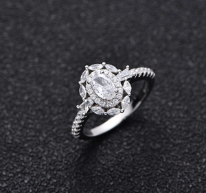 Macro shot of 925 silver halo ring featuring oval and marquise cut cubic zirconia