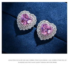 Macro detail of heart-shaped pink diamond earrings with double halo in 925 sterling silver