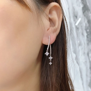 Long S925 sterling silver dangle earrings with square crystals on a female model