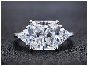 Macro detail of cushion cut center stone and trillon side stones on 925 silver ring
